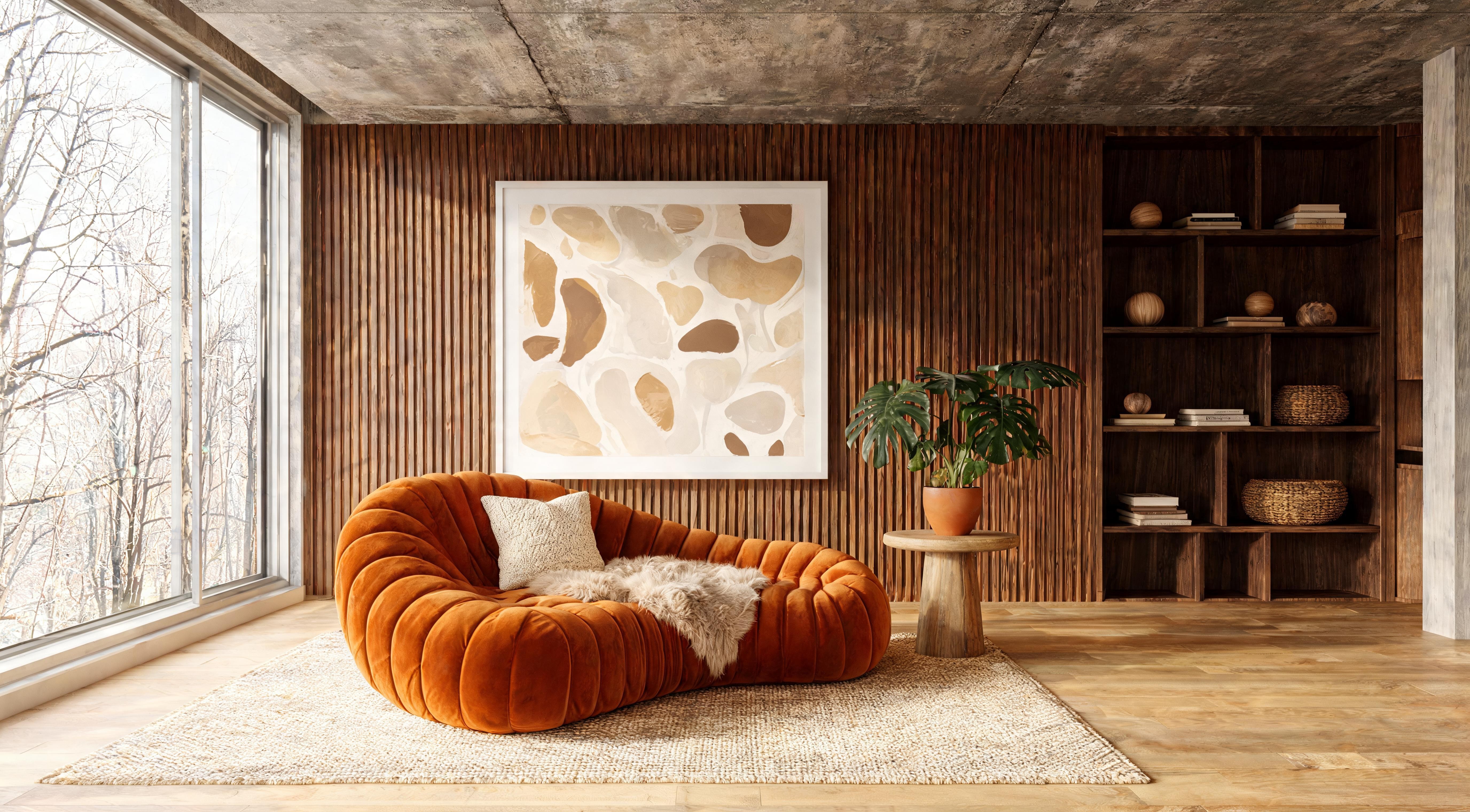 A living room with dark wood fluted panels as a full feature wall, an orange velvet sofa, large artwork and floor-to-ceiling shelving